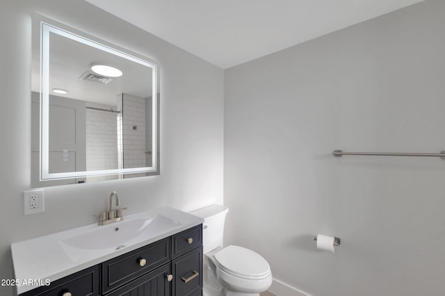 bathroom with vanity, toilet, and visible vents