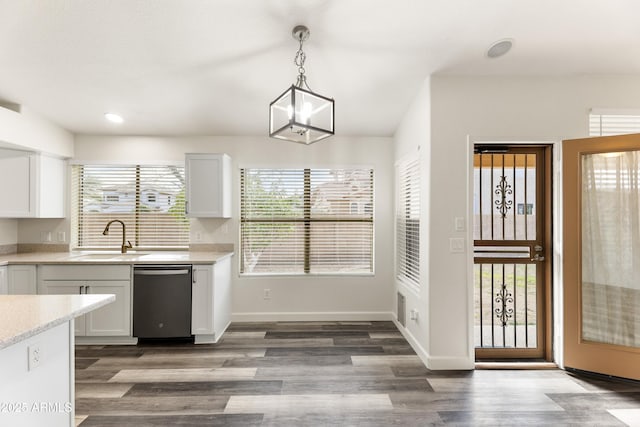 kitchen featuring a sink, stainless steel dishwasher, wood finished floors, and white cabinetry