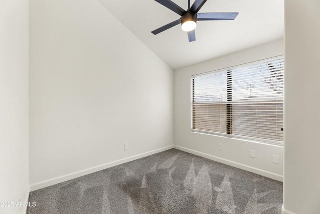 carpeted spare room with baseboards, a ceiling fan, and vaulted ceiling