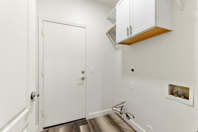 laundry room featuring wood finished floors, hookup for a gas dryer, cabinet space, hookup for an electric dryer, and hookup for a washing machine