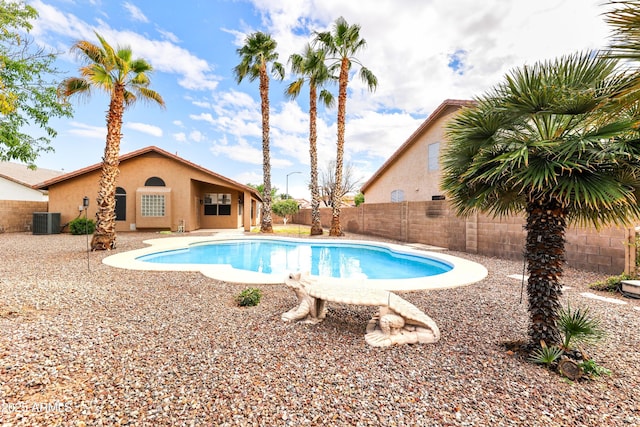 view of swimming pool with a patio, central AC unit, a fenced in pool, and a fenced backyard