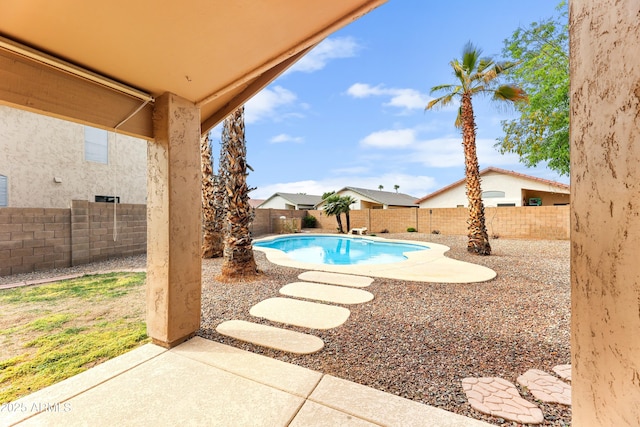 view of swimming pool with a patio area, a fenced in pool, and a fenced backyard