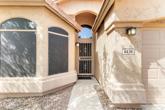 entrance to property with stucco siding