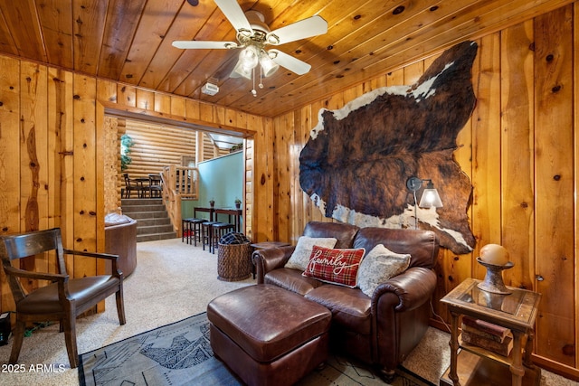 2 Acr 1027 Rd, Greer, AZ 85927 - sitting room featuring carpet flooring, wood ceiling, wooden walls, a ceiling fan, and stairs