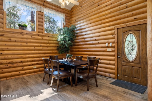 2 Acr 1027 Rd, Greer, AZ 85927 - dining room featuring plenty of natural light, hardwood / wood-style flooring, ceiling fan, and rustic walls