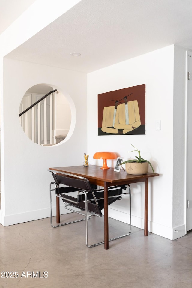 dining room with concrete flooring