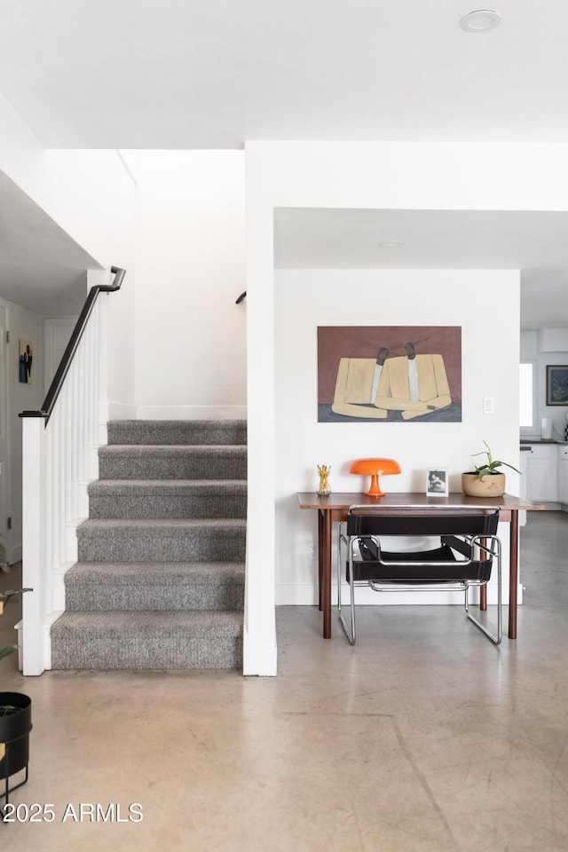 staircase with concrete flooring