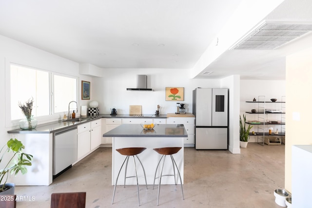 kitchen featuring sink, white refrigerator, dishwasher, white cabinets, and wall chimney range hood