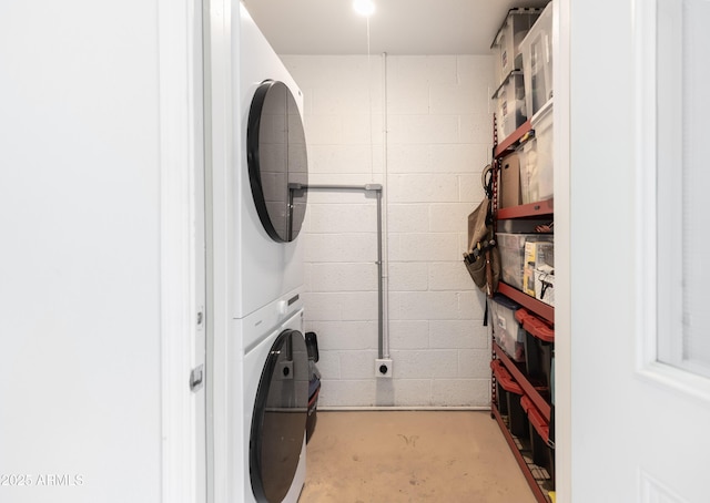 laundry room with stacked washing maching and dryer