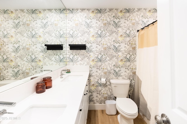 bathroom featuring walk in shower, vanity, toilet, and wood-type flooring