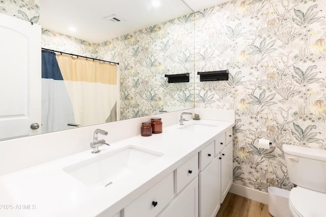 bathroom featuring vanity, hardwood / wood-style flooring, a shower with curtain, and toilet