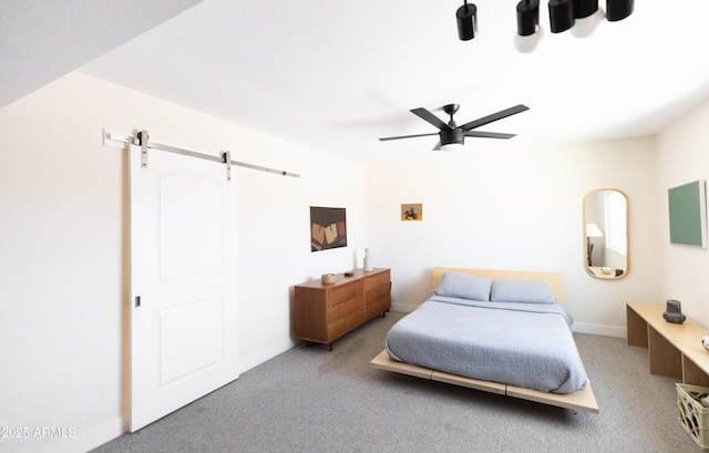 bedroom featuring ceiling fan, carpet flooring, and a barn door