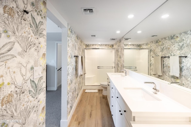 bathroom with vanity, hardwood / wood-style floors, toilet, and walk in shower