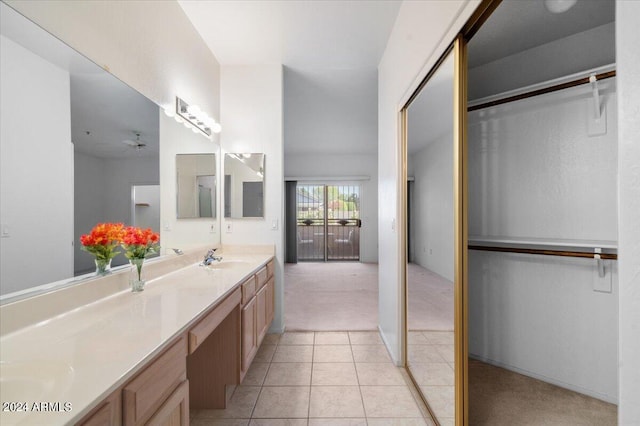 bathroom with ceiling fan, tile patterned flooring, and vanity