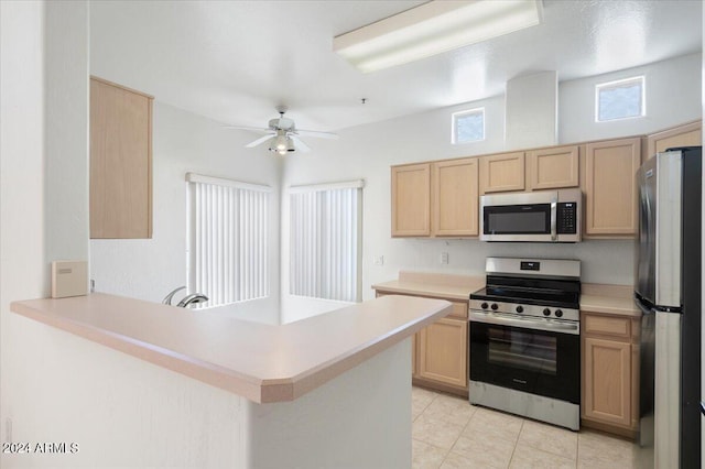 kitchen with ceiling fan, light tile patterned floors, light brown cabinetry, kitchen peninsula, and stainless steel appliances