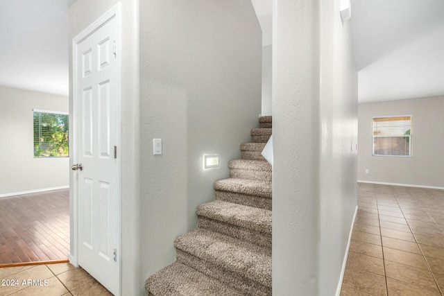 staircase featuring plenty of natural light and hardwood / wood-style floors