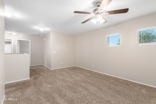 spare room featuring carpet and ceiling fan