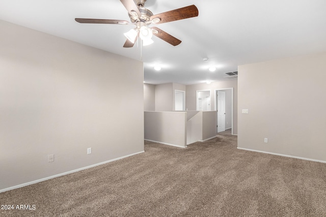 unfurnished room with ceiling fan and carpet flooring