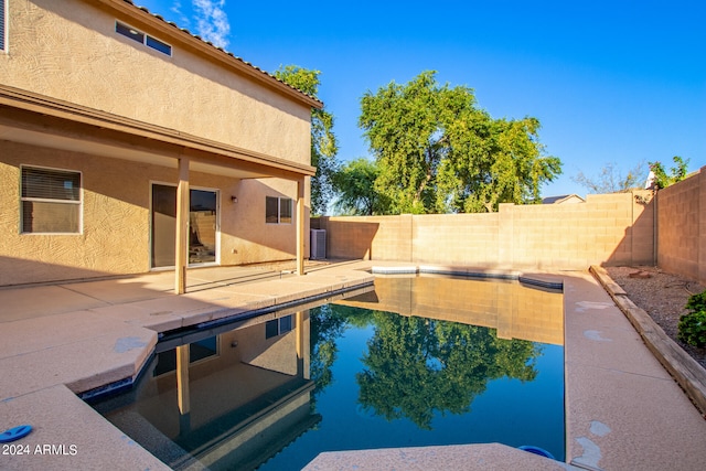 view of swimming pool with central AC unit and a patio area