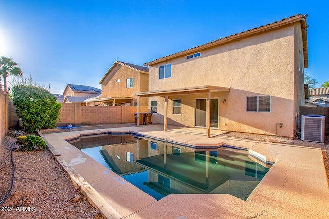 view of swimming pool featuring cooling unit and a patio area