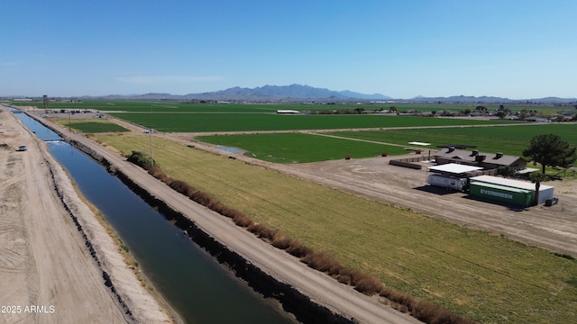 birds eye view of property featuring a water and mountain view and a rural view