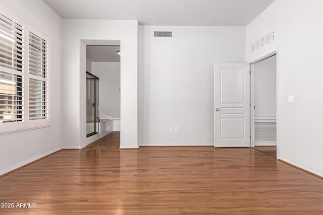 unfurnished room with hardwood / wood-style floors