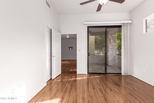 spare room with wood-type flooring and ceiling fan