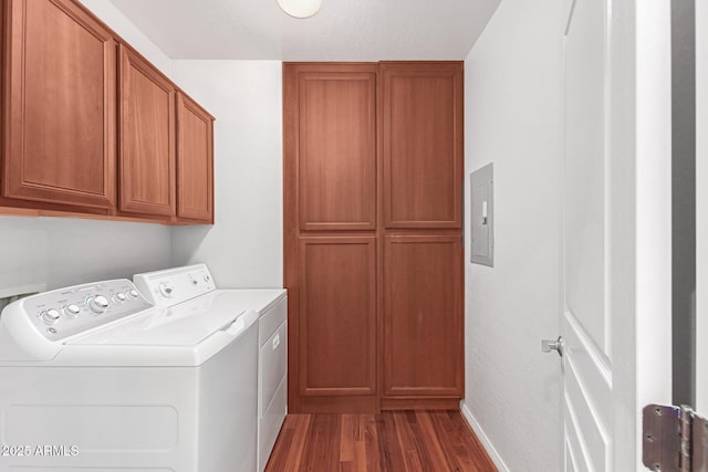 laundry room with dark hardwood / wood-style flooring, cabinets, and washing machine and clothes dryer