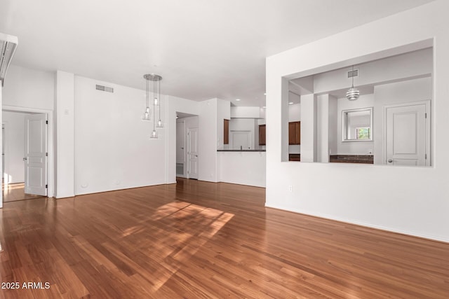 unfurnished living room featuring dark wood-type flooring