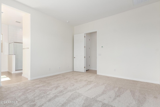 spare room with light carpet