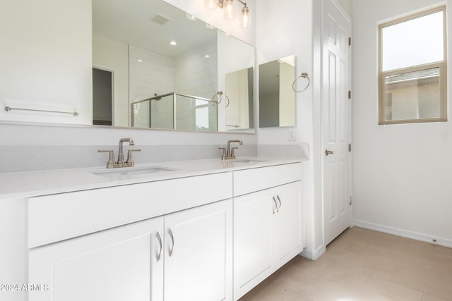 bathroom with tile patterned flooring, vanity, and an enclosed shower