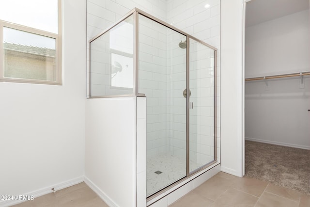 bathroom with tile patterned floors and walk in shower