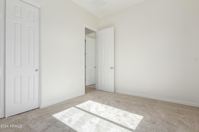 unfurnished bedroom with light carpet