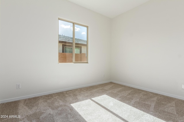 unfurnished room featuring light colored carpet