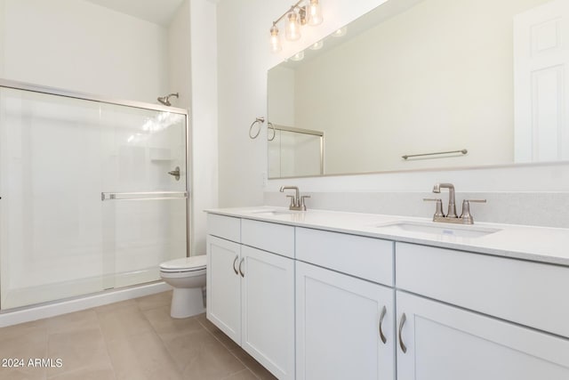 bathroom featuring tile patterned floors, vanity, toilet, and an enclosed shower