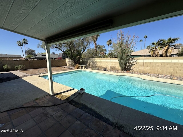 view of swimming pool with a fenced backyard, a patio, and a fenced in pool