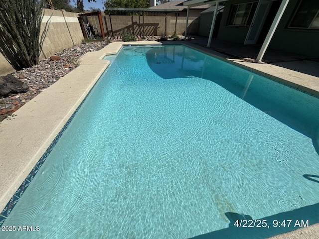 view of swimming pool with a patio area, a fenced backyard, and a fenced in pool