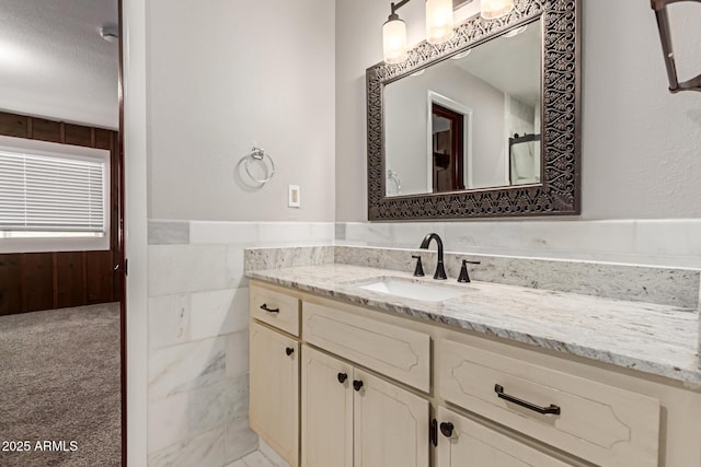 bathroom with wainscoting and vanity
