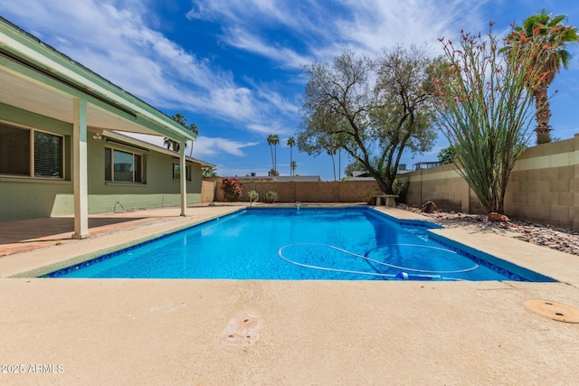 view of pool featuring a fenced backyard, a fenced in pool, and a patio area