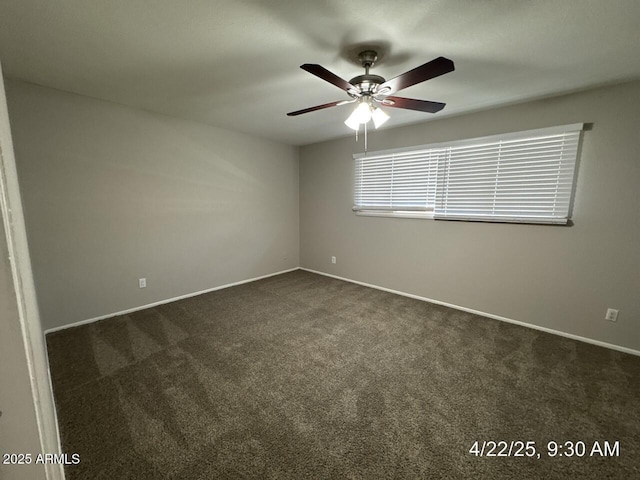 empty room with ceiling fan, baseboards, and dark colored carpet