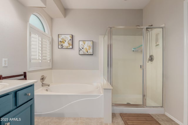 full bathroom featuring vanity, a shower stall, a garden tub, and tile patterned floors