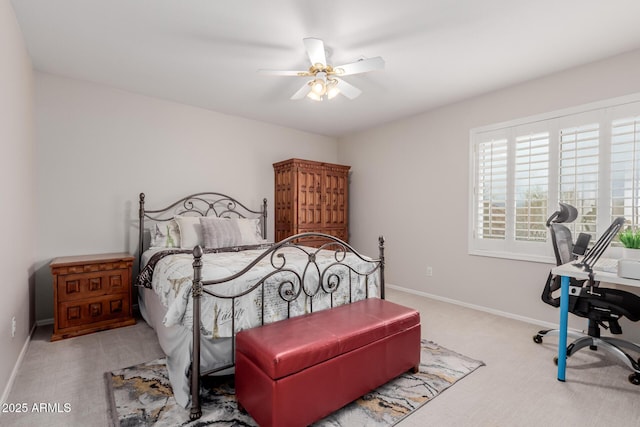 carpeted bedroom featuring baseboards and a ceiling fan