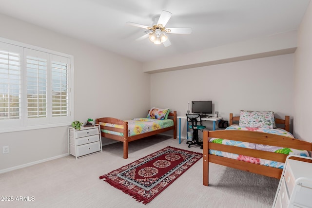 bedroom featuring light colored carpet, a ceiling fan, and baseboards