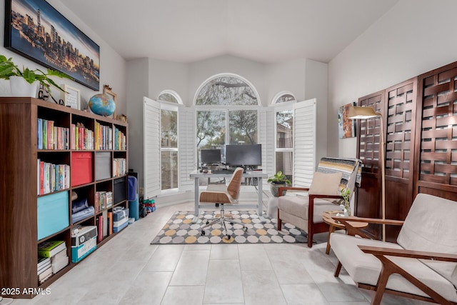 interior space with tile patterned floors and vaulted ceiling