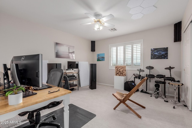 office area featuring visible vents, baseboards, light colored carpet, and a ceiling fan