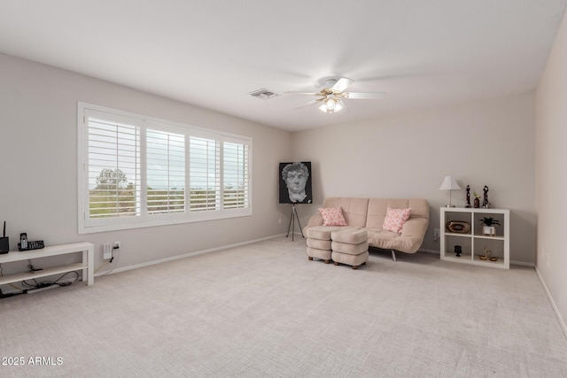 living area featuring baseboards, visible vents, carpet floors, and ceiling fan