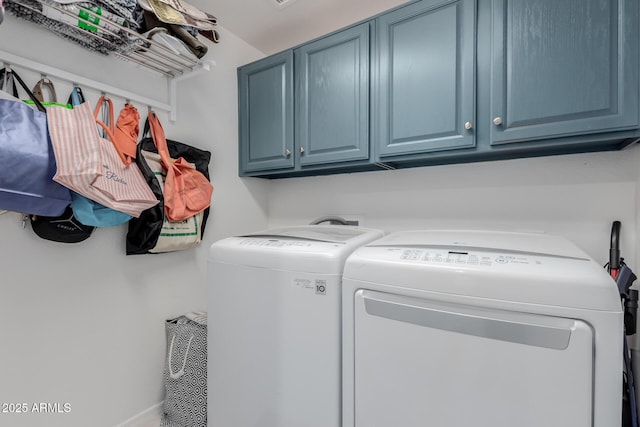 laundry area featuring washing machine and dryer and cabinet space