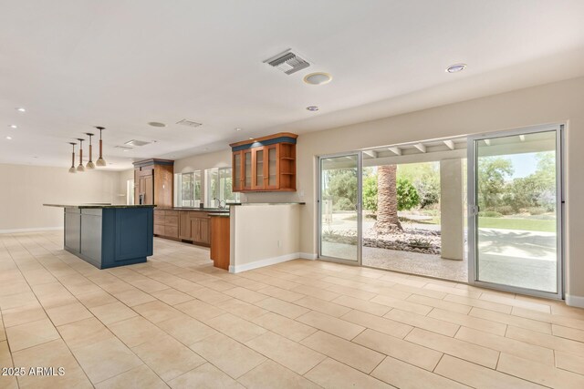 6102 E Aster Dr, Scottsdale, AZ 85254 - kitchen with open floor plan, brown cabinetry, glass insert cabinets, recessed lighting, and dark countertops
