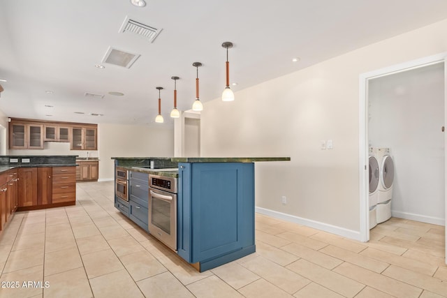 6102 E Aster Dr, Scottsdale, AZ 85254 - kitchen featuring washer and dryer, stainless steel oven, dark countertops, blue cabinetry, and recessed lighting