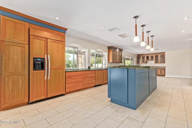 6102 E Aster Dr, Scottsdale, AZ 85254 - kitchen with paneled built in fridge, dark countertops, recessed lighting, glass insert cabinets, and a kitchen island